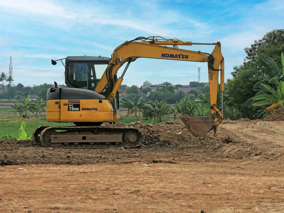 Excavator working at a rural construction site