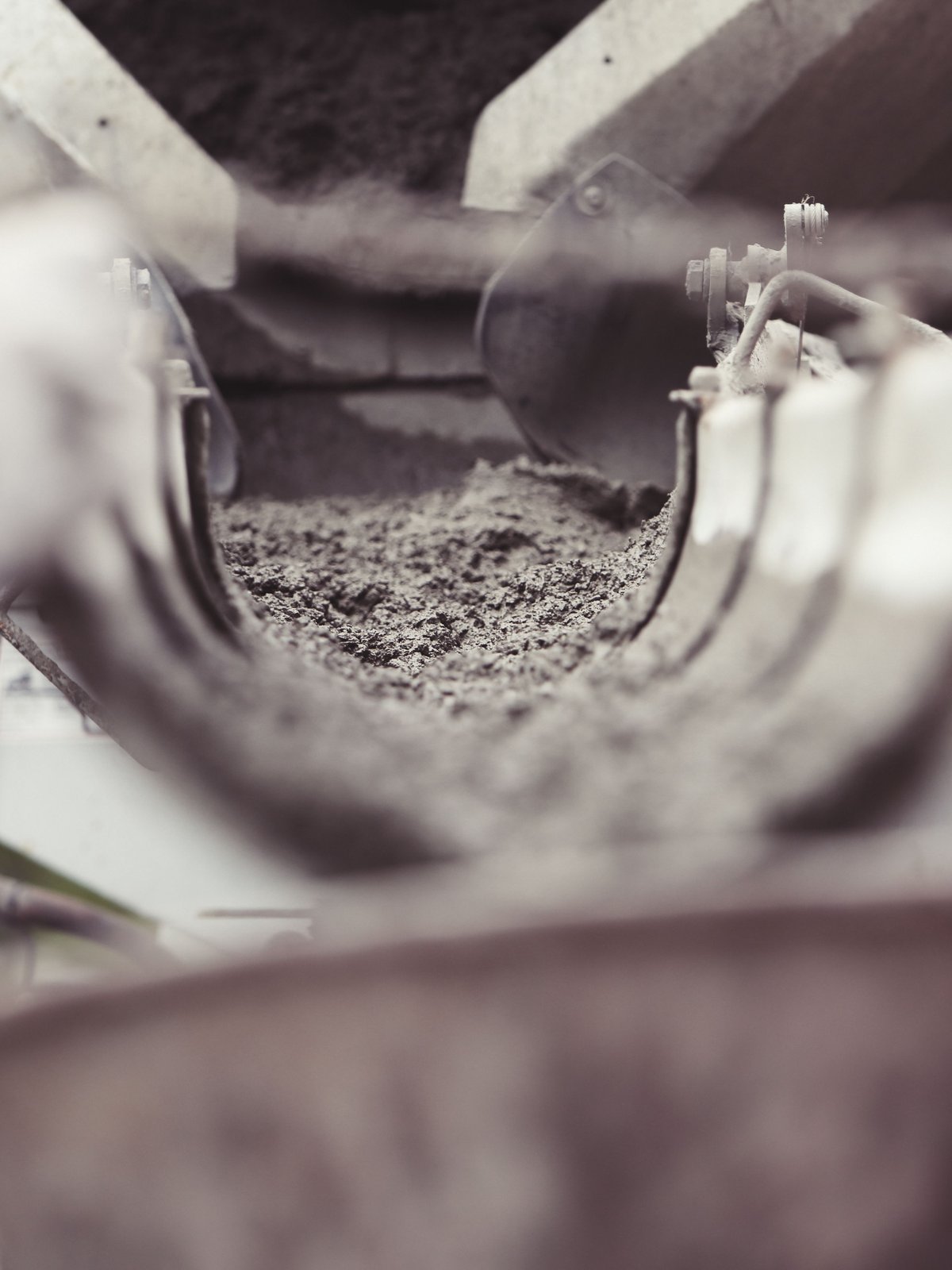Concrete being mixed and poured at a construction site